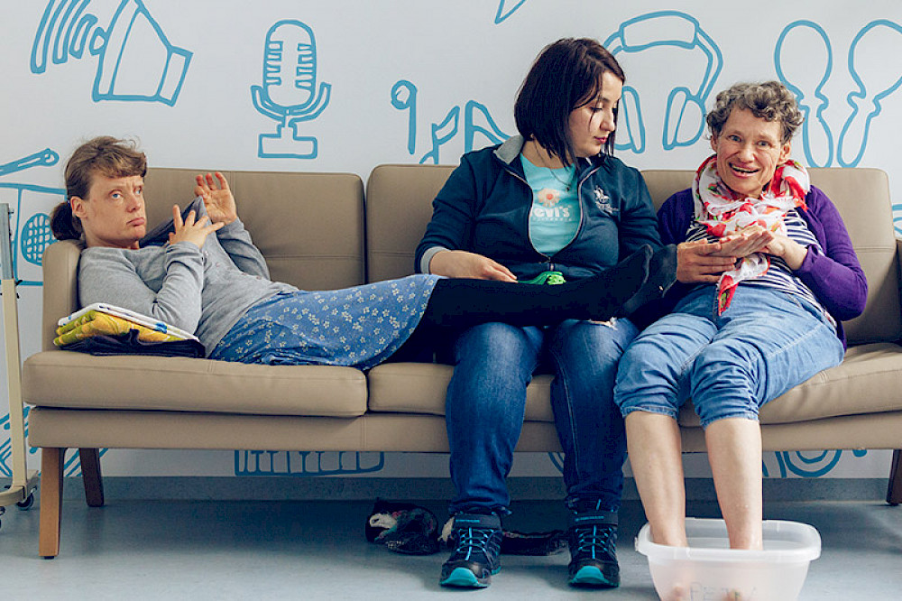 Image shows several people on a sofa.